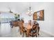 Elegant dining room with chandelier, stylish seating for six, and access to living room and water view at 17821 Gulf Blvd # B, Redington Shores, FL 33708