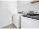 A functional laundry room with a stacked washer and dryer unit and wire shelving at 17821 Gulf Blvd # B, Redington Shores, FL 33708