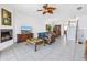 Spacious living room featuring a fireplace, access to dining area, and a staircase to the upper level at 17821 Gulf Blvd # B, Redington Shores, FL 33708