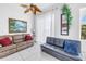 Bright living room with tile floors, ceiling fan, and comfortable leather seating at 17821 Gulf Blvd # B, Redington Shores, FL 33708