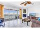 Cozy living room with fireplace, water views, balcony access, and stylish furniture at 17821 Gulf Blvd # B, Redington Shores, FL 33708