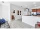 Open living space with views to kitchen, powder room, and staircase at 17821 Gulf Blvd # B, Redington Shores, FL 33708