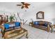 Inviting living room with elegant sofas, staircase, and a view into the dining area at 17821 Gulf Blvd # B, Redington Shores, FL 33708