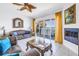 Open living room with balcony access offering waterfront views, a fireplace, and stylish decor at 17821 Gulf Blvd # B, Redington Shores, FL 33708
