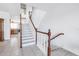 Staircase with white risers and wood handrail leading to upper level and view of kitchen at 17821 Gulf Blvd # B, Redington Shores, FL 33708