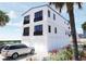 The home is a multi-level property featuring garage space, black accents, and waterfront views at 2004 Gulf Blvd, Indian Rocks Beach, FL 33785
