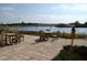 Outdoor seating area with tables overlooking a lake and fountain, perfect for relaxation and socializing at 2426 Sifield Greens Way, Sun City Center, FL 33573