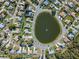 Aerial view of a community showcasing a central pond surrounded by well-maintained single-Gathering homes and lush landscaping at 26 Clintwood Ave, Englewood, FL 34223