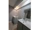 Modern bathroom with double vanity, white countertops, and dark fixtures at 26 Clintwood Ave, Englewood, FL 34223