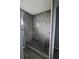 Modern bathroom showcasing a tiled shower with a pebble floor at 26 Clintwood Ave, Englewood, FL 34223