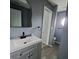 Bathroom featuring a modern vanity with a black faucet and gray color scheme at 26 Clintwood Ave, Englewood, FL 34223