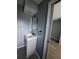 Compact bathroom vanity with modern fixtures and a stylish mirror, offering a contemporary look at 26 Clintwood Ave, Englewood, FL 34223