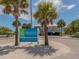 Englewood Beach at Chadwick Park with palm trees, blue skies, and a coastal building at 26 Clintwood Ave, Englewood, FL 34223