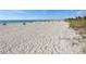Expansive beach view featuring white sand, clear turquoise water, and people enjoying the sun at 26 Clintwood Ave, Englewood, FL 34223