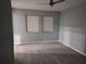 Bedroom featuring neutral walls, modern ceiling fan, and two windows for natural light at 26 Clintwood Ave, Englewood, FL 34223