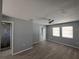 Bright bedroom with gray walls, ceiling fan, laminate floors, and natural light at 26 Clintwood Ave, Englewood, FL 34223