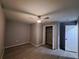 Bedroom with gray walls, ceiling fan, closet, and modern vinyl flooring at 26 Clintwood Ave, Englewood, FL 34223