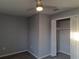 Cozy bedroom with gray walls, ceiling fan, closet, and modern vinyl flooring at 26 Clintwood Ave, Englewood, FL 34223