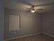 Bedroom featuring neutral walls, a ceiling fan, and a window with natural light at 26 Clintwood Ave, Englewood, FL 34223