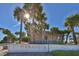 Welcome to Manasota Beach sign surrounded by lush palm trees and bright sunshine at 26 Clintwood Ave, Englewood, FL 34223