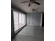 Spacious enclosed patio with tile flooring and ceiling fans, great for entertaining at 26 Clintwood Ave, Englewood, FL 34223