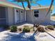 Home featuring well-maintained landscaping with decorative stone, complemented by mature trees and established shrubs at 26 Clintwood Ave, Englewood, FL 34223