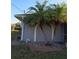 Charming home exterior with stucco siding, mature landscaping, and vibrant palm trees at 26 Clintwood Ave, Englewood, FL 34223