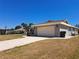 Single-story home with a two-car garage and long driveway at 26 Clintwood Ave, Englewood, FL 34223