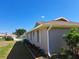 View of home exterior showing landscaped yard and window trim details at 26 Clintwood Ave, Englewood, FL 34223