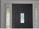 Close up view of the home's black front door with decorative glass at 26 Clintwood Ave, Englewood, FL 34223