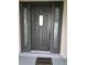 Elegant black front door featuring decorative sidelights and a 'Welcome' mat at 26 Clintwood Ave, Englewood, FL 34223