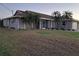 Single-story home featuring a neutral exterior, well-kept lawn, and palm tree landscaping at 26 Clintwood Ave, Englewood, FL 34223