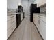 Modern kitchen featuring white cabinets, stainless steel appliances, and granite countertops at 26 Clintwood Ave, Englewood, FL 34223