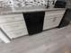 The kitchen features a sleek, black dishwasher with modern white cabinets and drawers, plus stylish gray countertops at 26 Clintwood Ave, Englewood, FL 34223