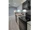 Modern kitchen with granite countertops, stylish backsplash, stainless steel sink, and black appliances at 26 Clintwood Ave, Englewood, FL 34223