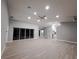 Spacious living room features sleek floors, recessed lighting, and sliding glass doors to bring the outside in at 26 Clintwood Ave, Englewood, FL 34223