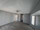 Spacious living room with gray walls, modern floors, ceiling fan, and lots of natural light at 26 Clintwood Ave, Englewood, FL 34223