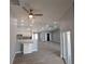 Open-concept living area with recessed lighting, ceiling fans, and light gray flooring at 26 Clintwood Ave, Englewood, FL 34223