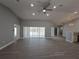 Open-concept living room with abundant natural light, ceiling fan and sliding glass doors leading to pool at 26 Clintwood Ave, Englewood, FL 34223