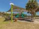 Shaded playground area with slides and picnic tables, perfect for Gathering fun and outdoor activities at 26 Clintwood Ave, Englewood, FL 34223