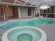 A relaxing screened-in pool and hot tub with tile trim offer a private backyard oasis at 26 Clintwood Ave, Englewood, FL 34223