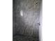 This walk-in shower features gray, rectangular tiles and a pebble floor at 26 Clintwood Ave, Englewood, FL 34223