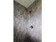 Modern tiled shower featuring a rainfall showerhead and pebble-stone shower floor at 26 Clintwood Ave, Englewood, FL 34223