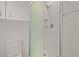Updated bathroom featuring white tile, glass shower door, and modern fixtures at 2850 41St N St, St Petersburg, FL 33713