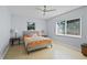 Cozy bedroom with a large window, tiled floors, a ceiling fan, and comfortable furnishings at 2850 41St N St, St Petersburg, FL 33713