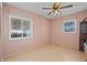 Bright dining room featuring tile floors, a ceiling fan, and natural light from two windows at 2850 41St N St, St Petersburg, FL 33713
