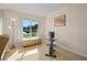 Bright workout area with large window, tile floor, exercise bike and bench at 2850 41St N St, St Petersburg, FL 33713