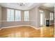 Bright dining room featuring hardwood floors, three shuttered windows, a tray ceiling, and a chandelier at 2880 Bayshore Trails Dr, Tampa, FL 33611