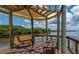 Picturesque gazebo featuring seating overlooks the water with lush greenery in the background at 2880 Bayshore Trails Dr, Tampa, FL 33611