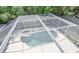 Aerial view of screened-in pool and patio area, providing a private and refreshing outdoor oasis for relaxation and recreation at 2880 Bayshore Trails Dr, Tampa, FL 33611